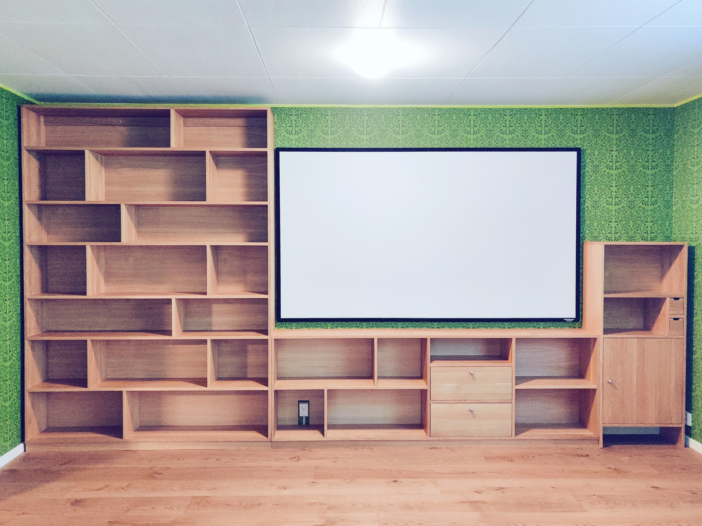 Kirjahylly tammesta, jossa eri levyiset hyllyvälit.